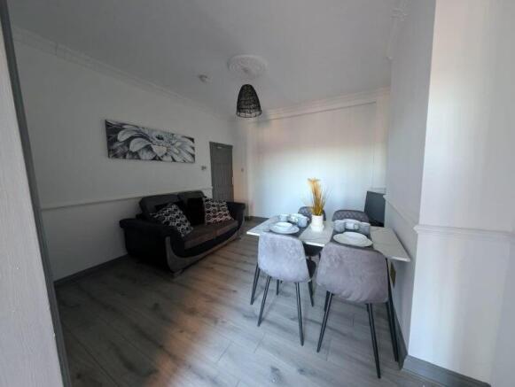 Bright, modern living and dining area with cont...