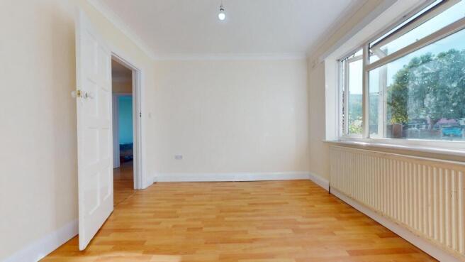 Bright bedroom with sleek wooden flooring...