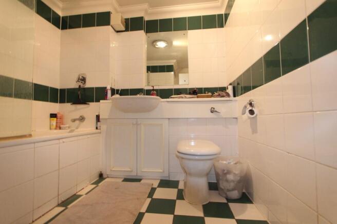 Spacious bathroom with bathtub and storage vani...