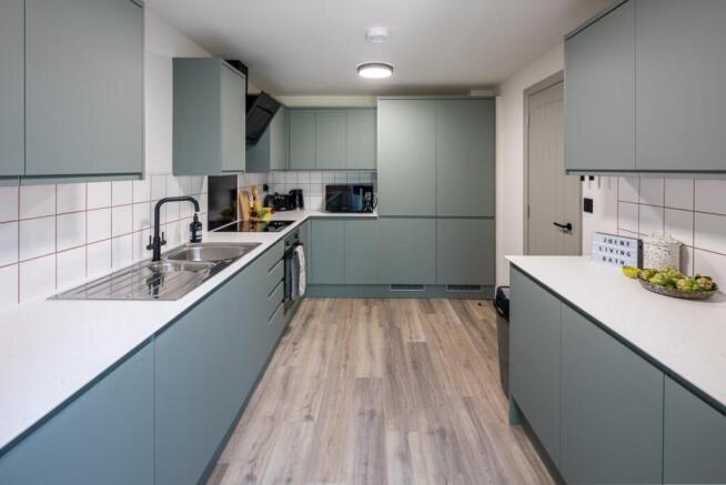 Modern kitchen with sage units and ample space...