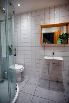 Bright modern bathroom with corner shower...