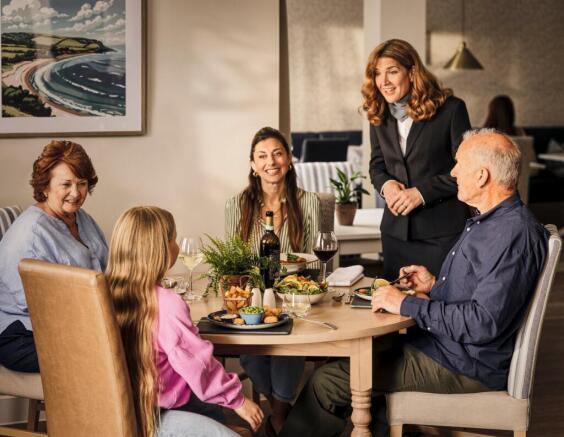 a group of people sitting around a table