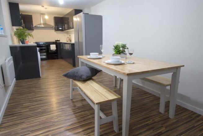 Bright, modern kitchen-diner with a wooden dini...