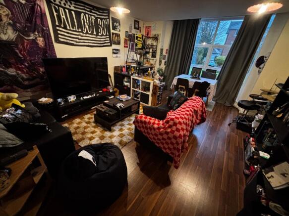 Bright, characterful living room with large win...