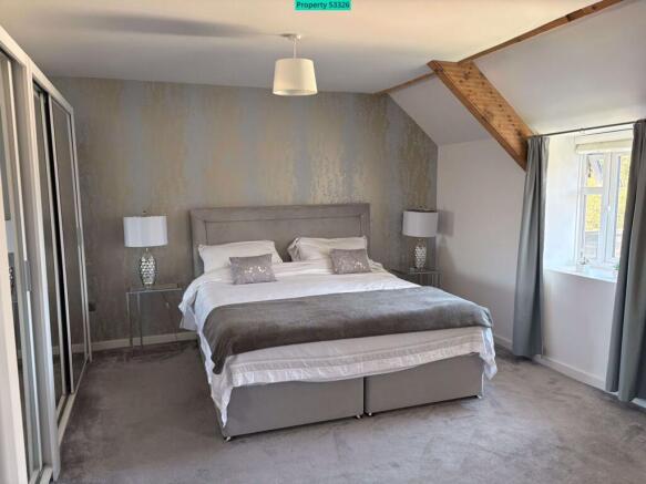 Master bedroom with fitted mirrored wardrobes
