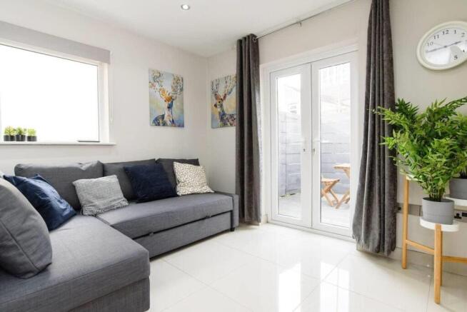 Bright lounge with patio doors and comfy sofa...