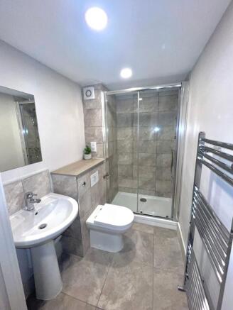 Modern tiled bathroom with a walk-in glass show...