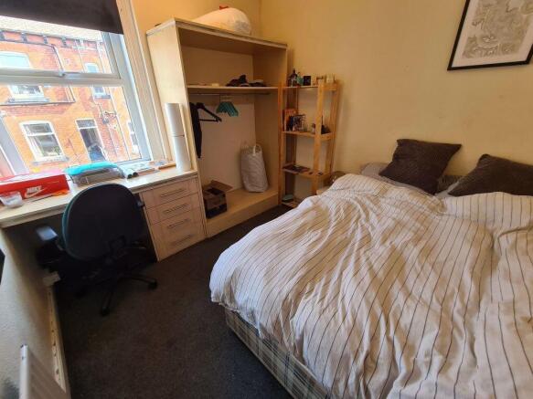 A cozy bedroom featuring a neatly made double b...