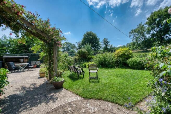 Rear Garden - rose arch and lawn.jpg