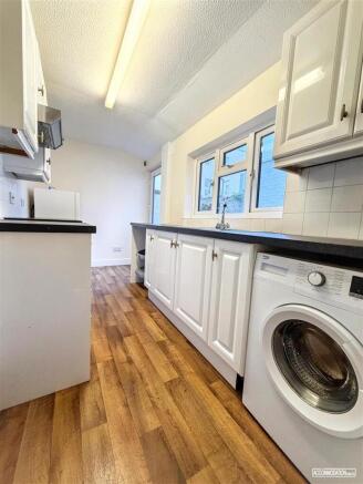 Bright galley kitchen with integrated washer...