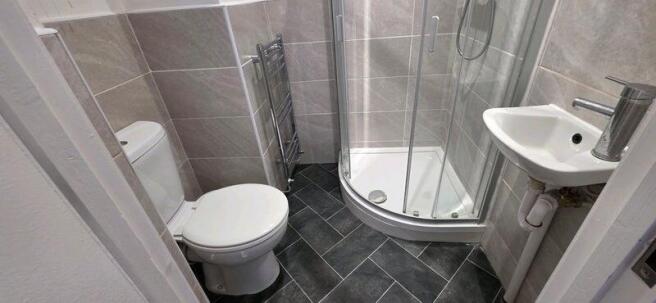 Modern tiled bathroom with corner shower...