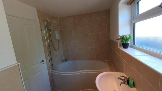 Bright bathroom suite with a modern bathtub...