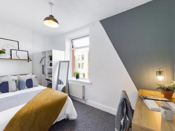 A bright and inviting double bedroom featuring ...