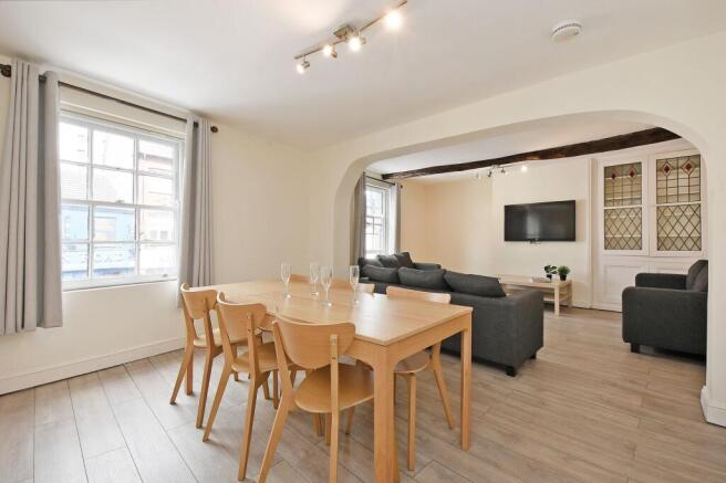 Bright, open-plan living and dining area with l...