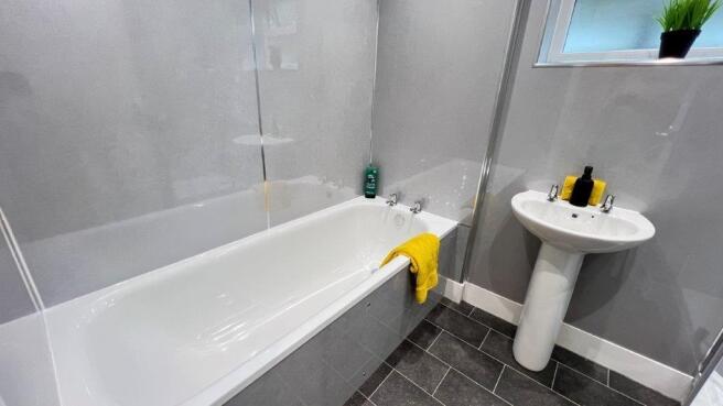 Modern bathroom with bath and bright finishes...