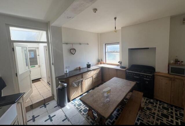 Bright kitchen with dining table and skylight...