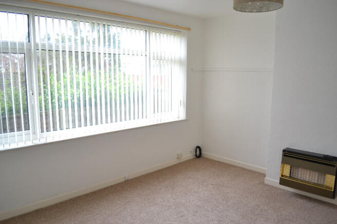 Living Room With Large Window Overlooking The Rear