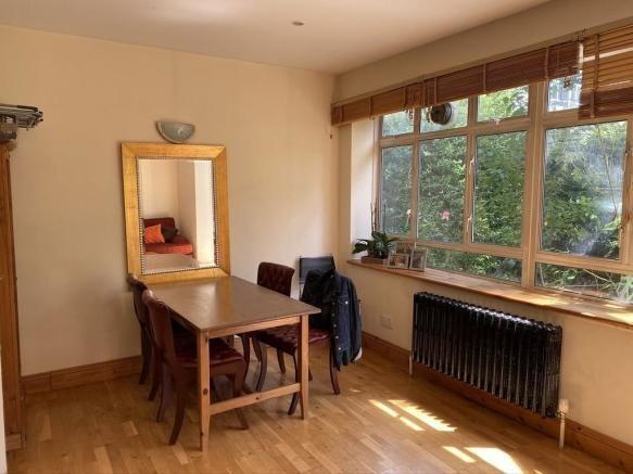 Bright living area with large windows and mirro...
