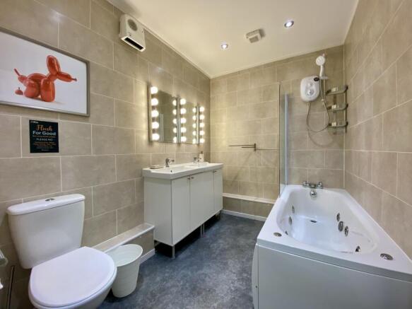 A spacious and modern bathroom featuring a luxu...