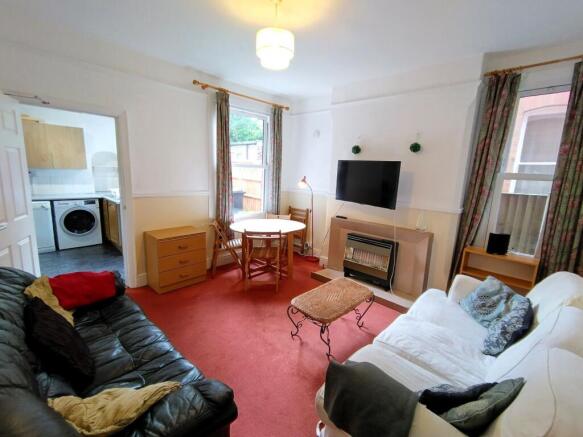 Bright carpeted lounge with seating and dining...