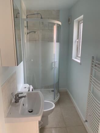 Modern bathroom with sleek glass corner shower...