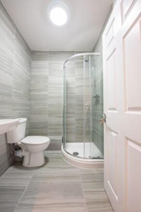 Modern tiled bathroom with sleek glass shower...