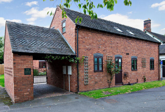 Front aspect showing car port and electric gate to