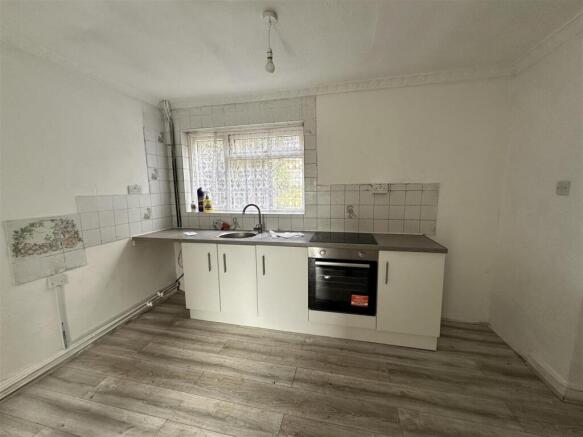 Spacious kitchen with modern fitted units and o...