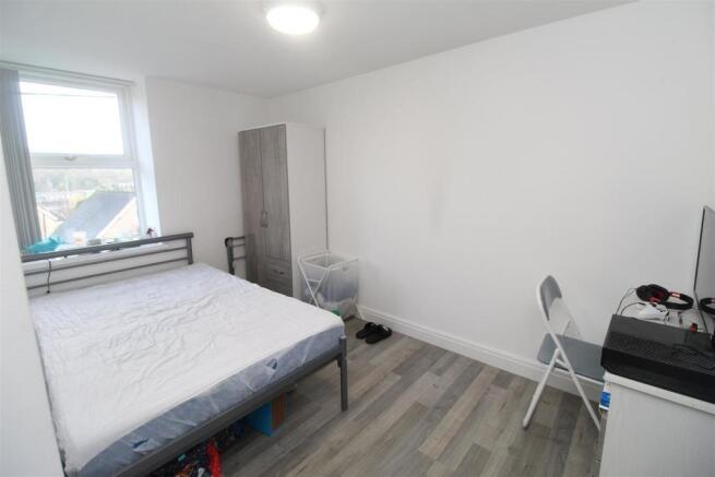 Bright double bedroom with modern grey flooring...