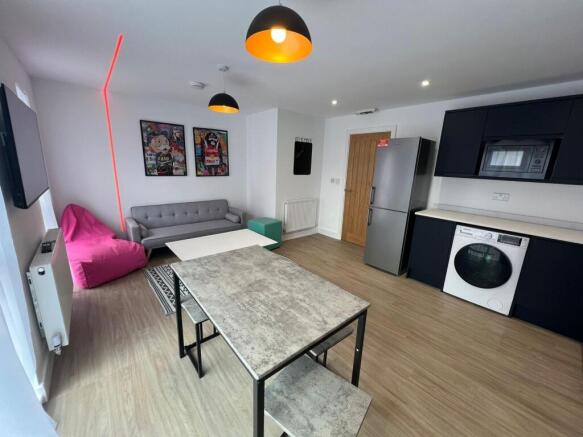 Bright open-plan living area with modern kitche...