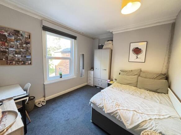 A well-maintained bedroom featuring a comfortab...