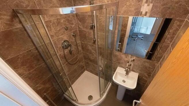 Modern tiled bathroom with sleek walk-in shower...