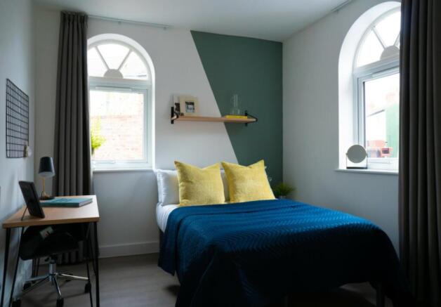 A beautifully designed double bedroom featuring...