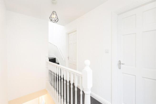 Bright, freshly painted upstairs hallway with w...