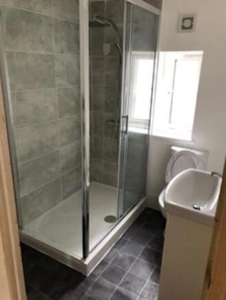 Bright and modern bathroom featuring a spacious...