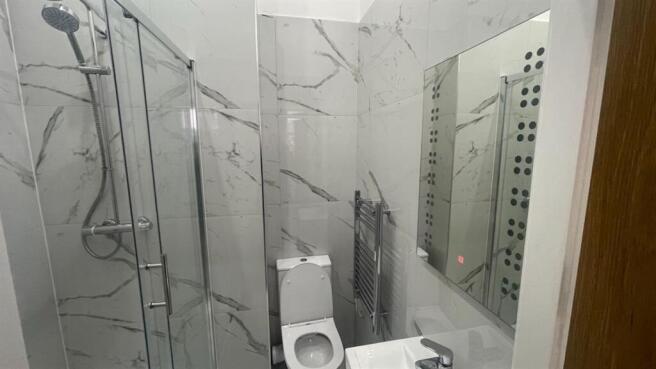 Modern bathroom with marble-effect wall tiles, ...