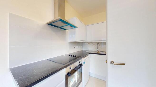 Bright, modern galley kitchen with sleek black ...