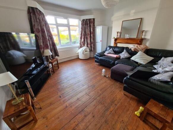 A spacious and well-lit living room featuring c...