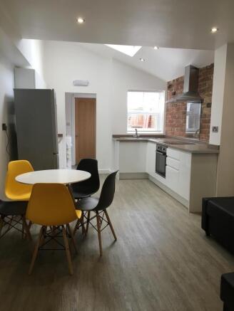 Bright modern kitchen with integrated oven, sta...