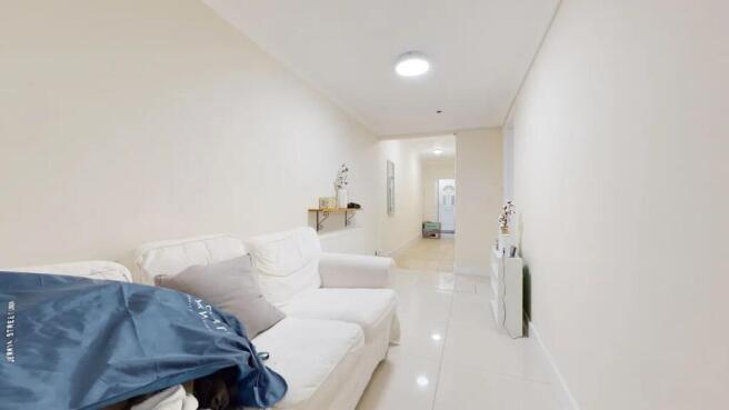 Bright and clean hallway featuring glossy tiled...