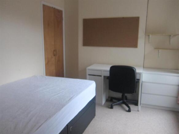 Bright bedroom with built-in desk and storage...