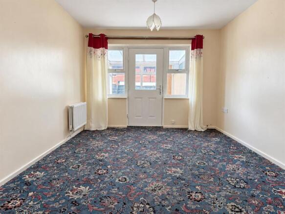 bright_empty_room_with_floral_carpet_and_french_do