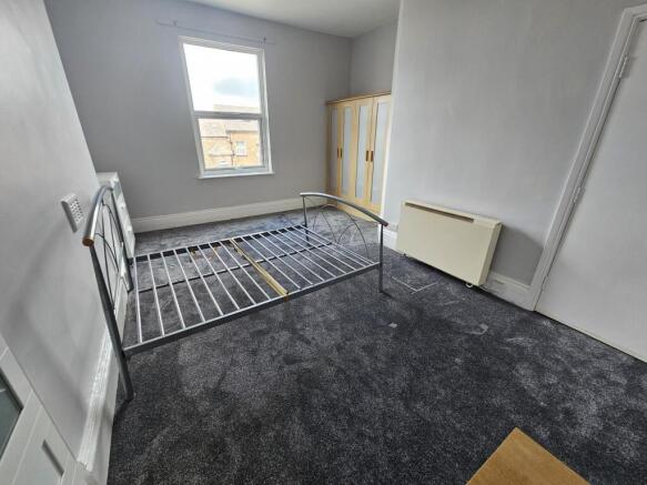 Bright, simply furnished double bedroom with a ...