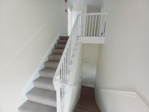 ENTRANCE HALL  AND STAIRS TO THE LANDING