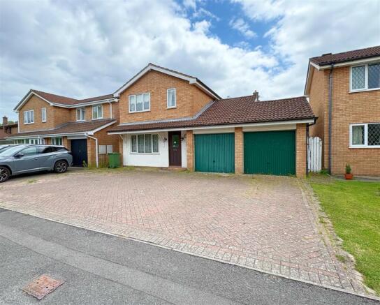 Front shot of property, double garage and driveway