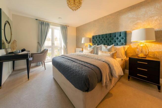 a bedroom with a bed and a desk