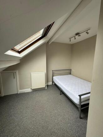 Bright attic bedroom with a skylight, simple me...