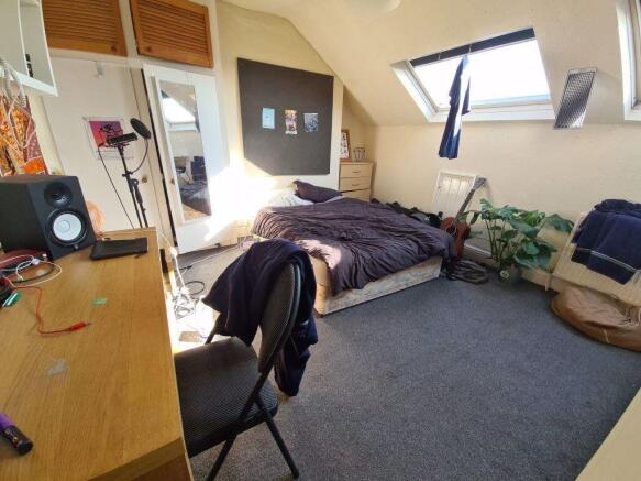 A bright and cozy bedroom with a neatly made be...