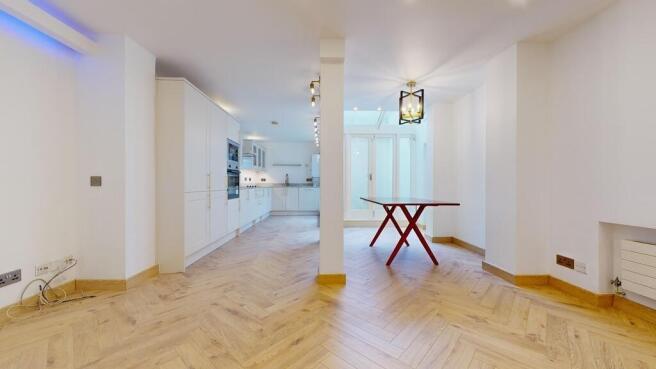 Bright open-plan kitchen with modern flooring...