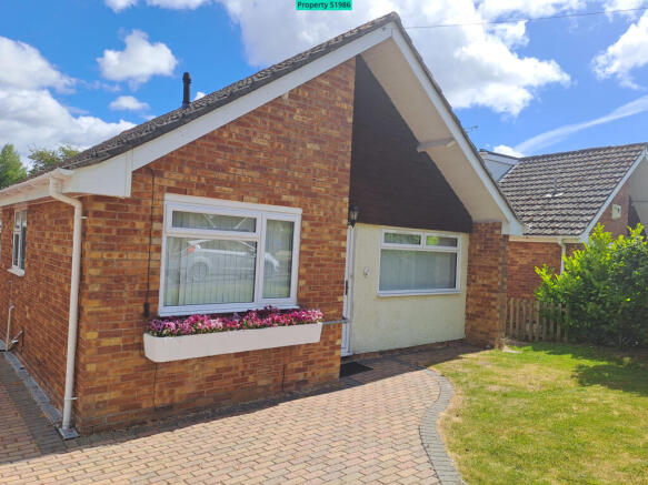 Front of house with garden and drive